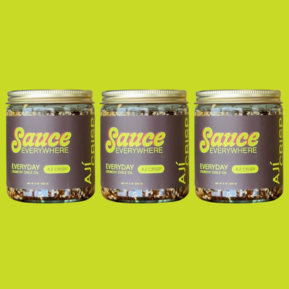 Three glass jars of Aji Crisp chile sauce by Sauce Everywhere against chartreuse background.
