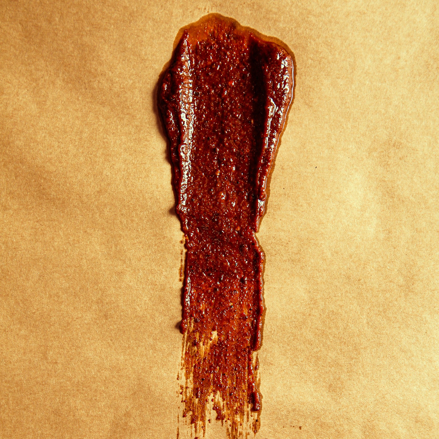 Maroon Casera sauce with thick consistency smeared on butcher paper.